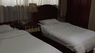 2-ух местная кровать в номере гостиницы Юйшаньху г. Хуньчунь