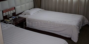 2-ух местная кровать в номере гостиницы Кайюе в г. Хуньчунь